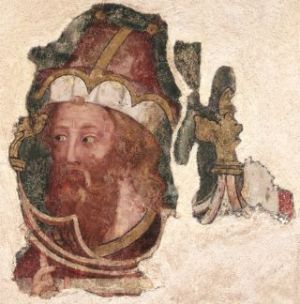 Männerkopf mit rotem Haar und Vollbart bekleidet mit einer hohen Mütze in einem ornamentalen Rahmen